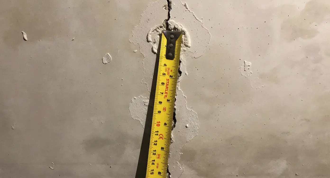 Completed crack injection repair showing sealed foundation wall crack with cured epoxy resin creating watertight bond across full wall depth